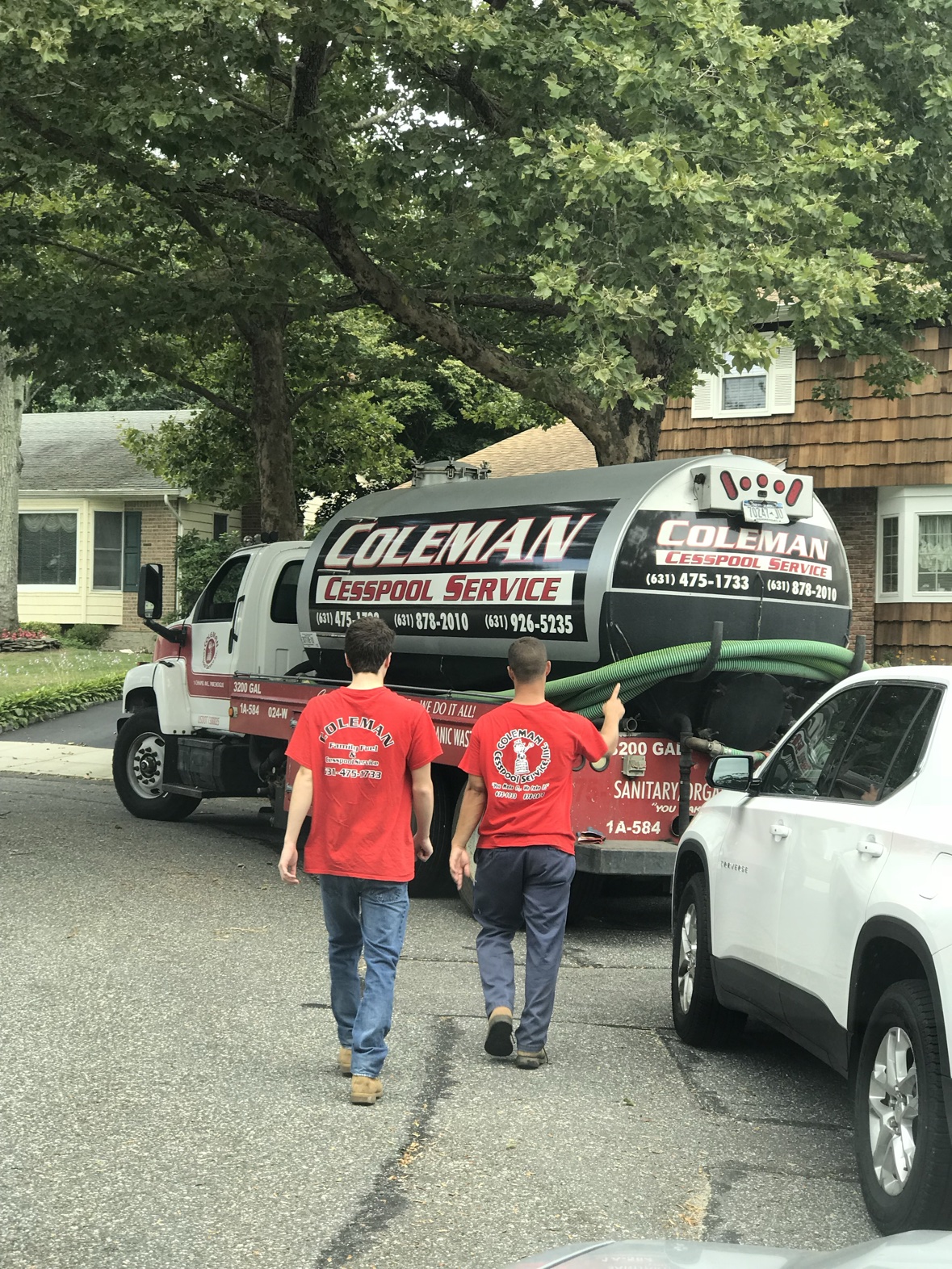 Coleman Cesspool truck and crew at a residential service call